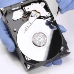 hands-repairing-hard-drive-high-angle